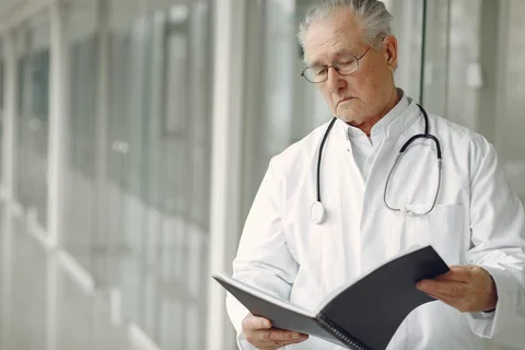 A healthcare practitioner reads a report.